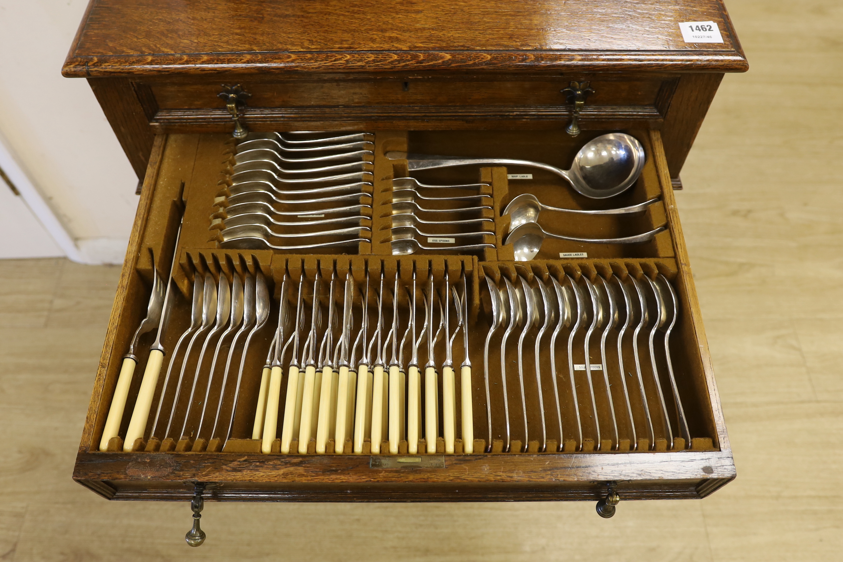 An oak standing canteen with two drawers of Mappin and Webb silver plated cutlery, settings for twelve people, 78cm high x 70cm wide x 54cm deep